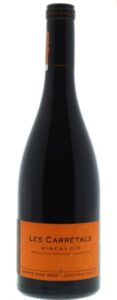A bottle of Domaine Anne Gros and Jean-Paul Tollot Les Carrétals Minervois red wine with a bright orange label, set against a plain white background.