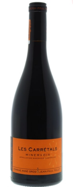 A bottle of Domaine Anne Gros and Jean-Paul Tollot Les Carrétals Minervois red wine with a bright orange label, set against a plain white background.
