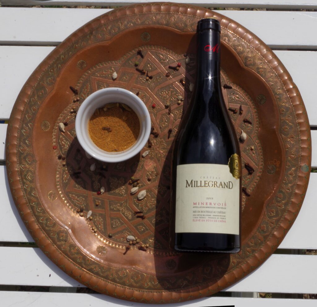 A nice service plate with spices and a bottle of Minervois red wine C.D.O.