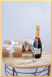 Presents on a table for a celebration with cahmpagne