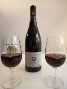 A focus on the bottle of Morgon Côte Du Py from Laurent Perrachon winery. along with two nice glasses of beaujolais wine.