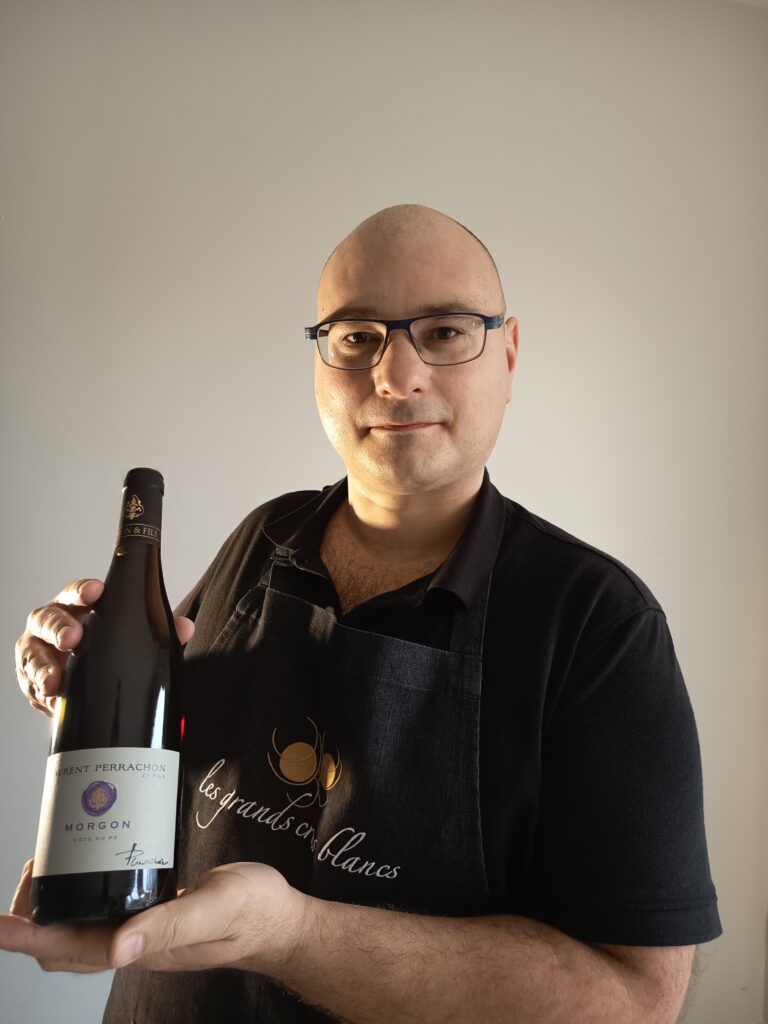 The sommelier introduces his Morgon Côte Du Py beaujolais wine bottle from Laurent Perrachon winery.