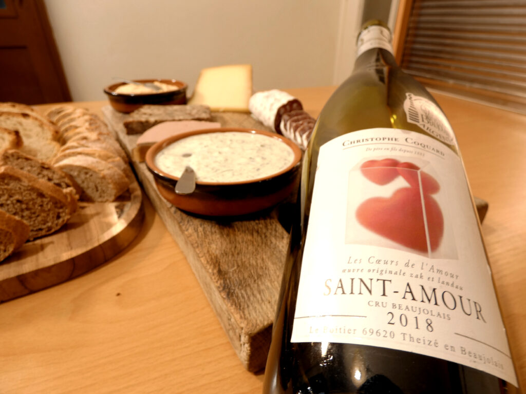 A Saint Amour Beaujolais wine from Christophe Coquard winery along with a charcuterie board.